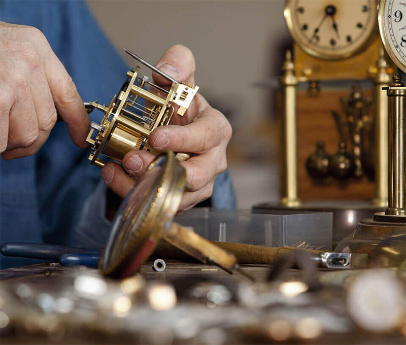 Man working on repairing a clock