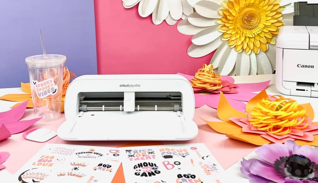 A cricut machine on a table full or projects