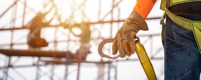 Man holding a clip high up on a rooftop