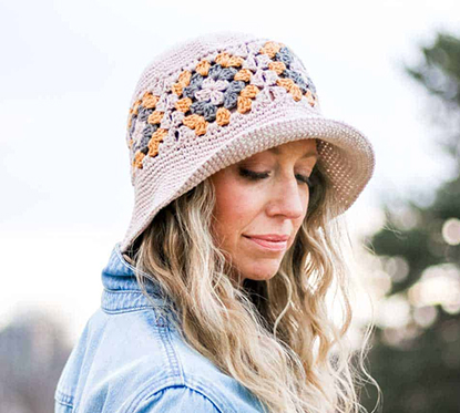 Woman wearing granny square bucket hat