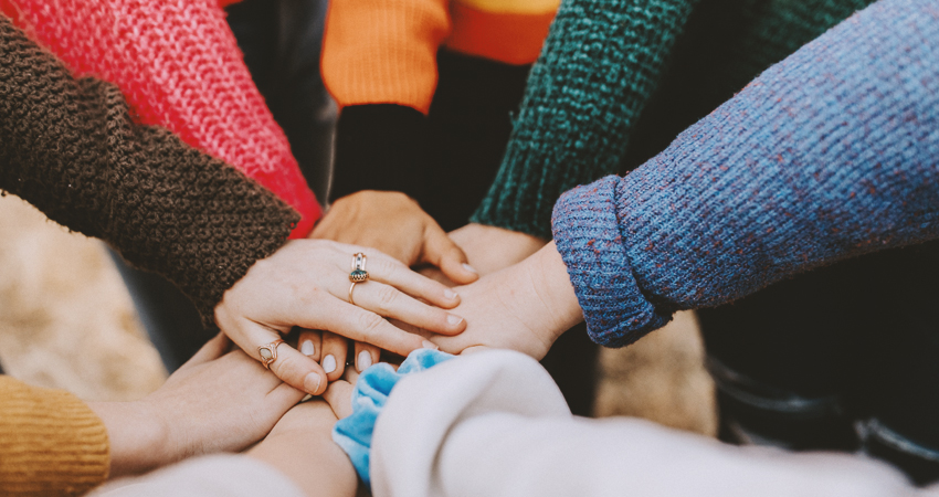 friends hands piled together