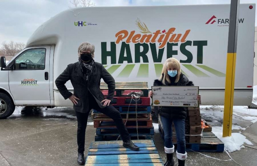 Jeff Burrows presents a cheque to June Muir, of the Windsor Essex Food Bank Association