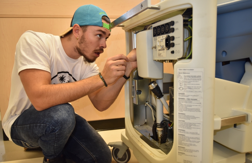 A majority of Ontarians support three-year College degrees for programs like the one shown in the photograph of a student in Biomedical Engineering Technology.