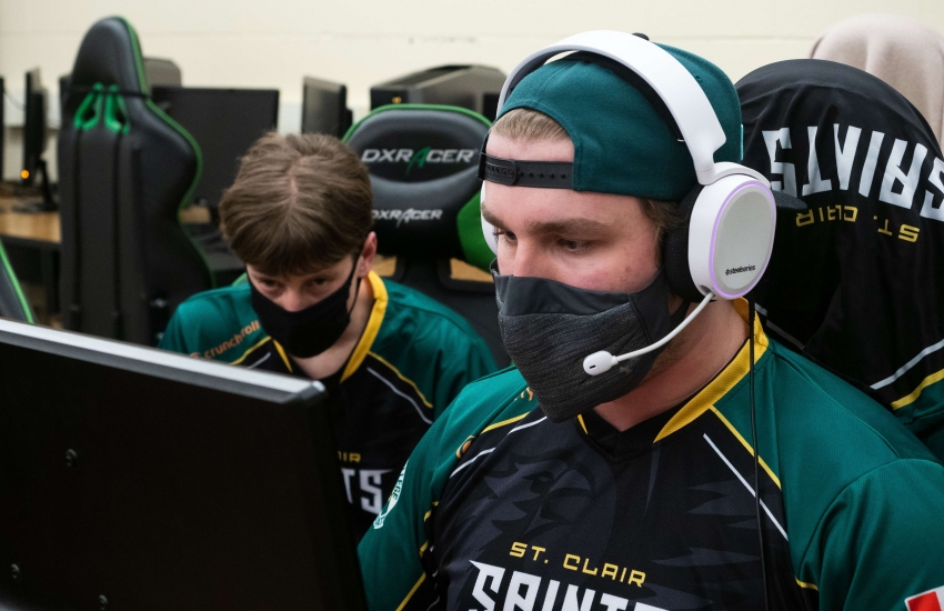 Saints Esports team gaming on a computer.