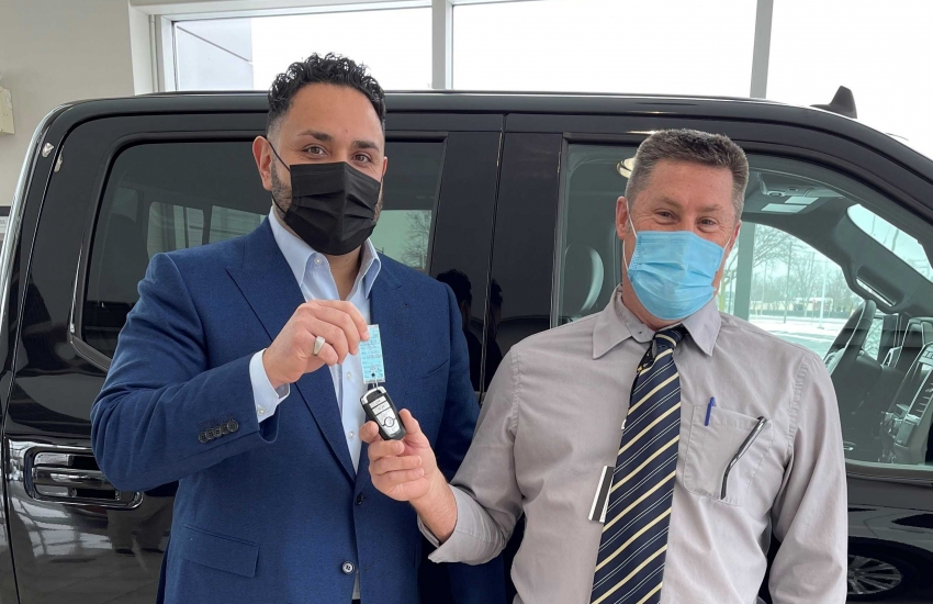 Zeyad Rafih, Executive Vice President of the Rafih Auto Group at Performance Ford in Windsor, hands the keys to Dale Sinnaeve, Manager of Operations Skilled Trades, Apprenticeship and Engineering.