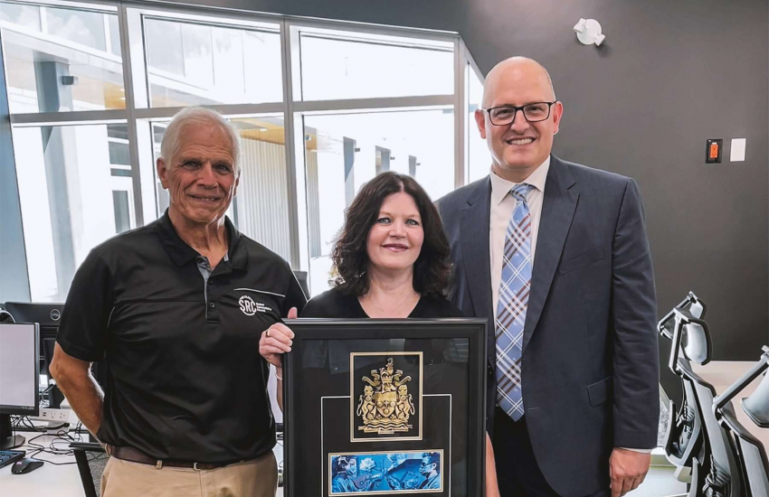 Patti France holding the key to the city while posing with Don France and Mayor Drew Dilkens