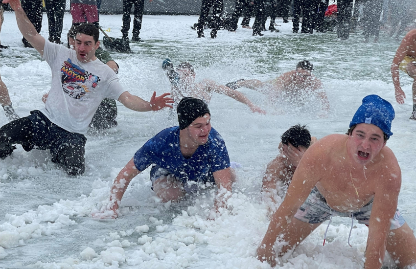 Students participating in polar slip n slide