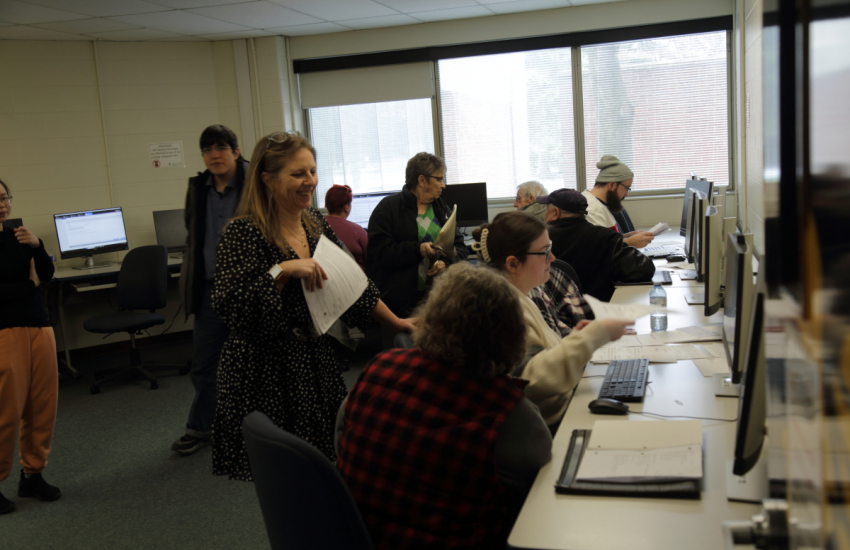 Seniors getting help with their taxes on computers