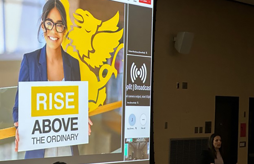 Presentation with Rise Above graphic on screen