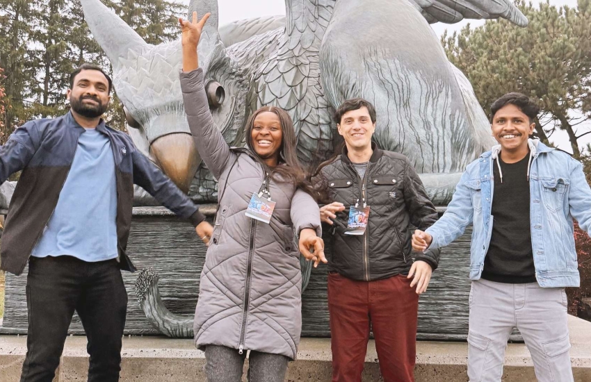 Students from St. Clair College in front of a statue