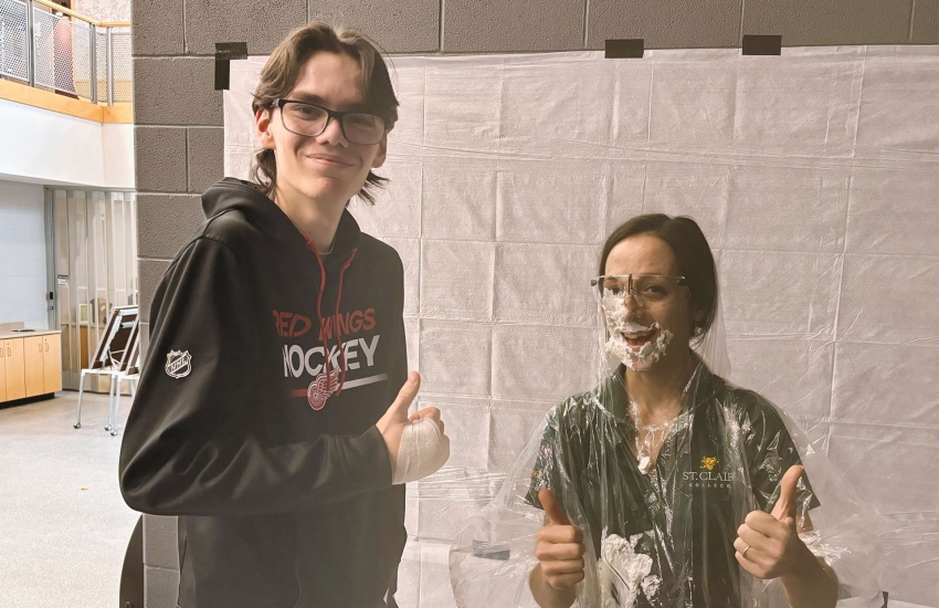 Student William Bradford and math professor Katrina Tomanelli are still on talking terms after Bradford smushed a pie in her face for the 'pie your prof' fundraiser on Dec. 6, 2024.