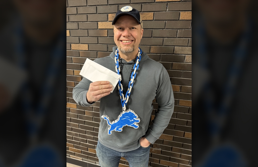 Don Smith holds a pair of tickets to the Detroit Lions playoff game
