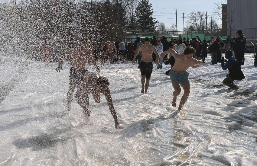 St. Clair College students slip and slide across an icy field