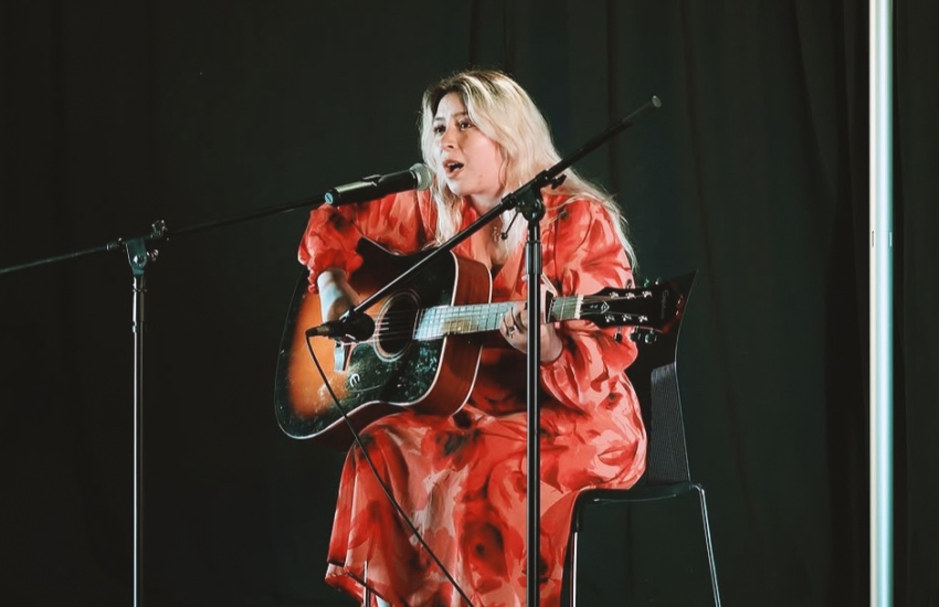 Second-year St. Clair College Journalism student Paula Bunay performing on stage
