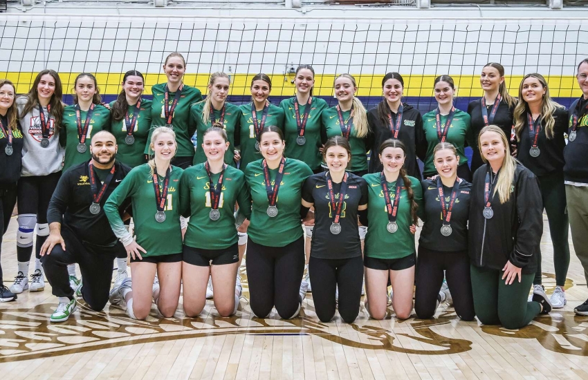 The Saints Women's Volleyball team poses with their silver medals