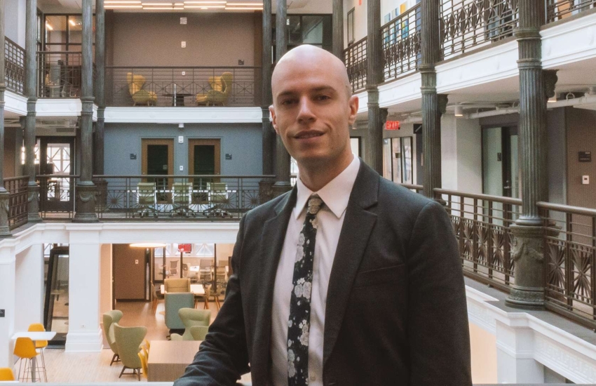 Sam McCutcheon poses inside Harvard Medical School
