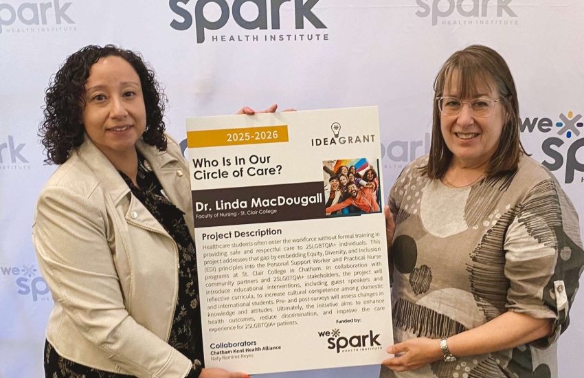 2 women holding sign