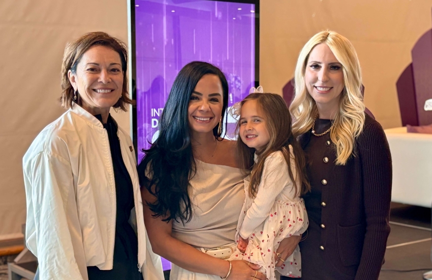 Monica Staley Liang, Nour Hachem (with her daughter) and Yvonne Pilon pose for a picture at the International Day of the Girl at the St. Clair College Centre for the Arts on Oct. 9, 2025.