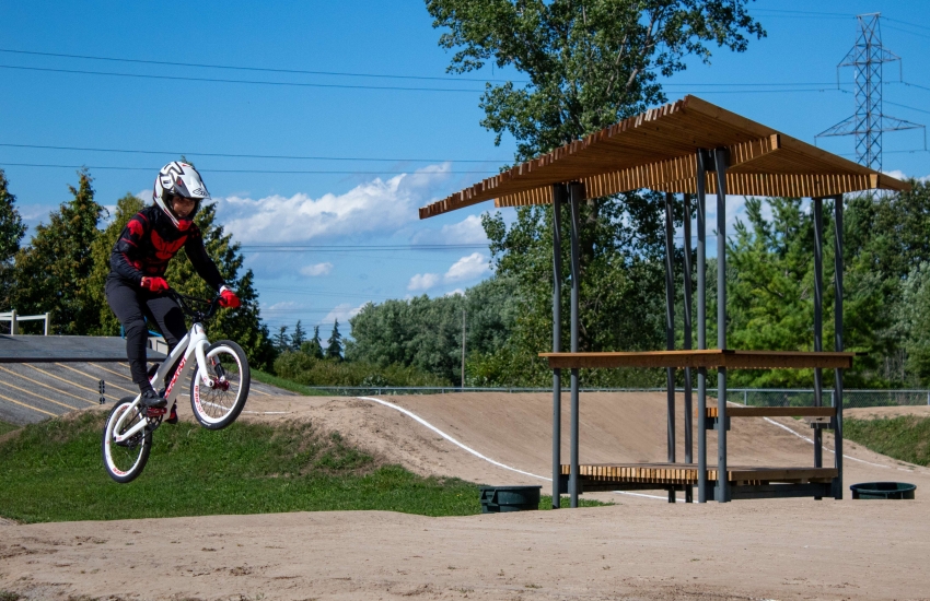 A BMX rider takes a jump next to the new announcing tower pavilion at Wolfe Creek BMX Racetrack in Chatham. 
