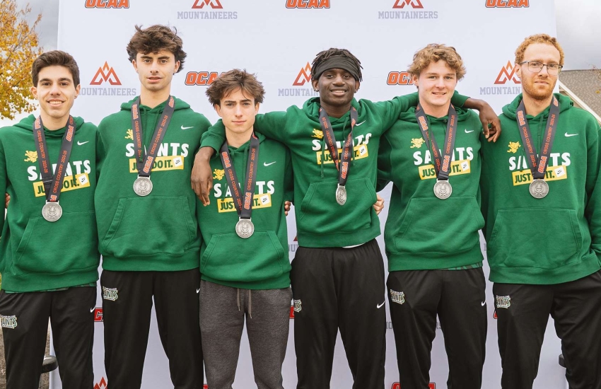 The St. Clair Saints Men's Cross-Country team posing with their silver medals