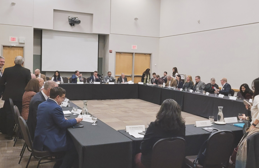 People sitting at a rectangle of tables