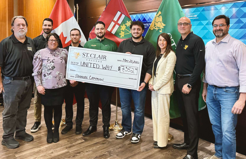Members of St. Clair College's administration, support staff, student government and faculty unions present a cheque to United Way Windsor-Essex Chatham-Kent