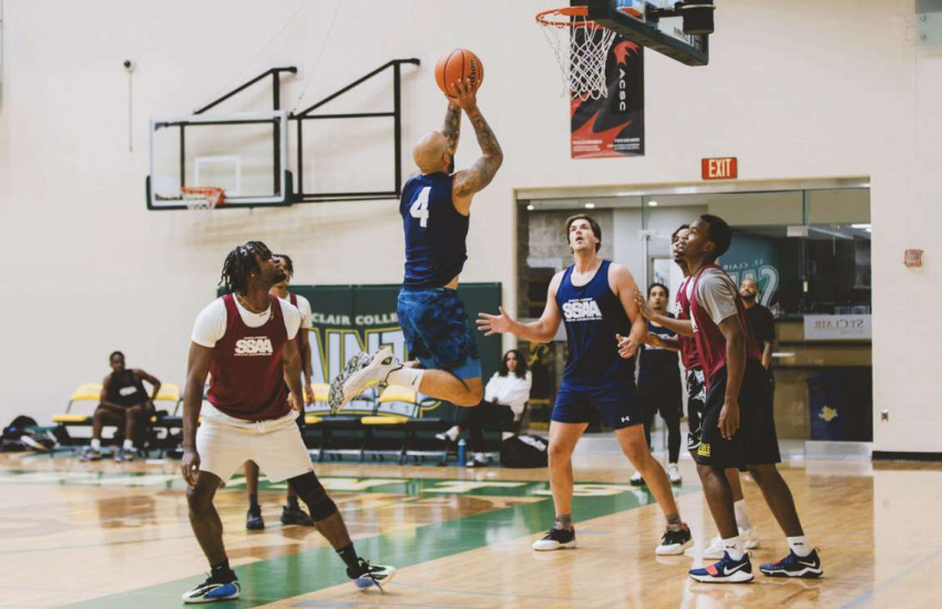 Man taking jump shot near basket