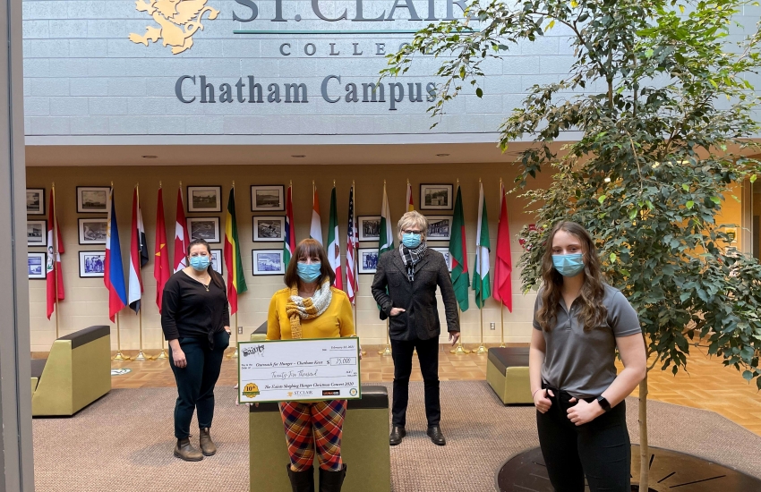 Jeff Burrows and Thames Students Inc. president Hannah LaCroix present a cheque to Brenda LeClair of Outreach for Hunger - Chatham Kent