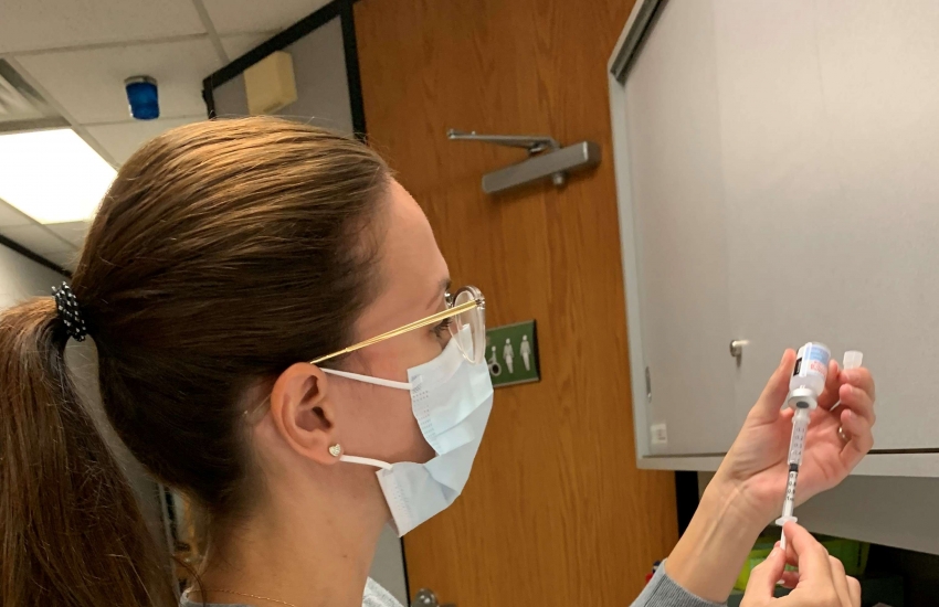 Campus nurse Stacy Manzerolle prepares the COVID-19 vaccines on Wednesday.