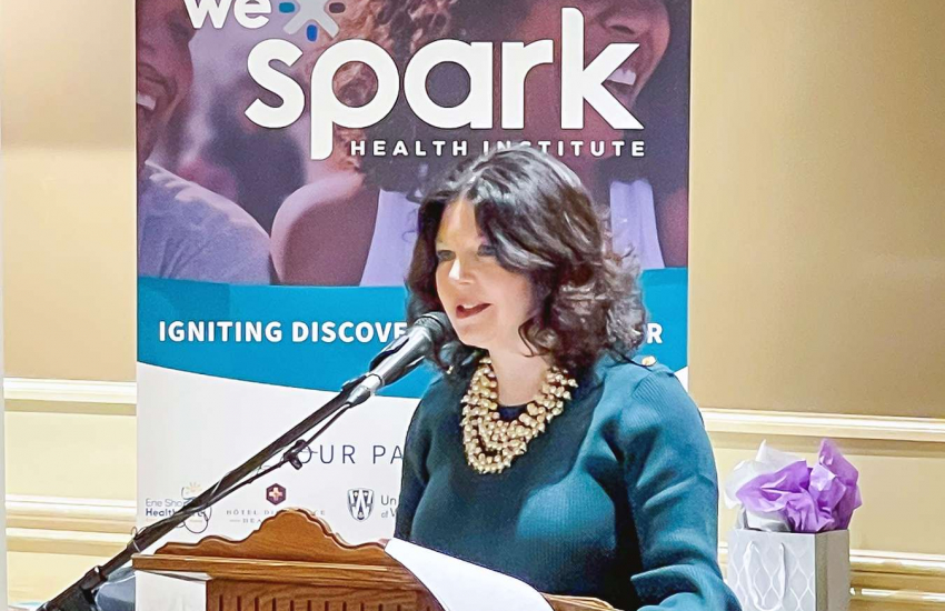 Dr. Patti France speaking at the podium