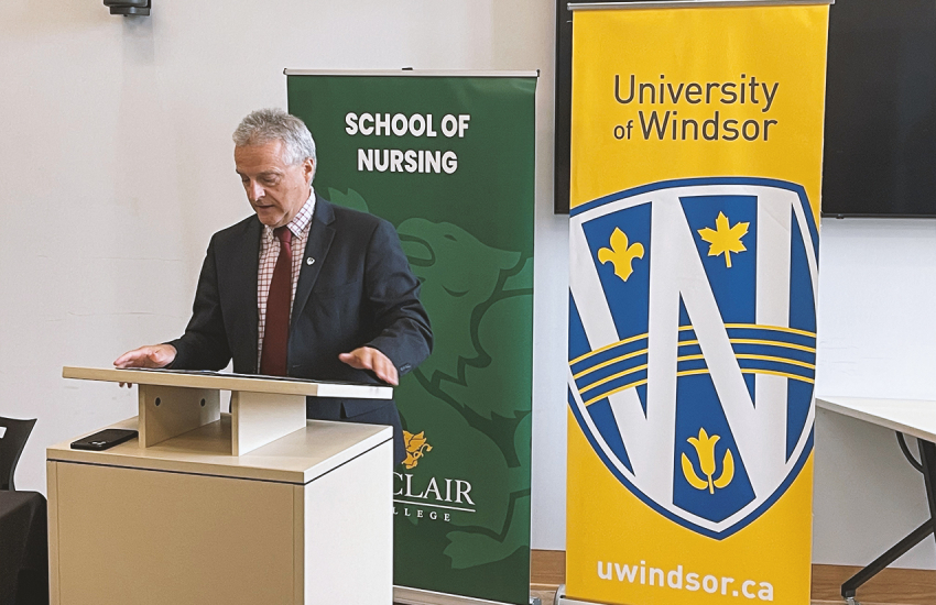 UWindsor President Robert Gordon speaking at a podium