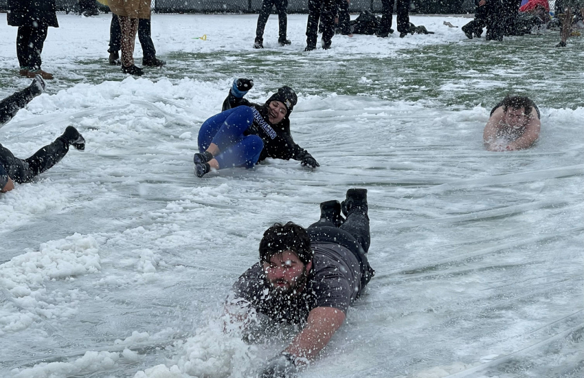 Students sliding on slip n slide