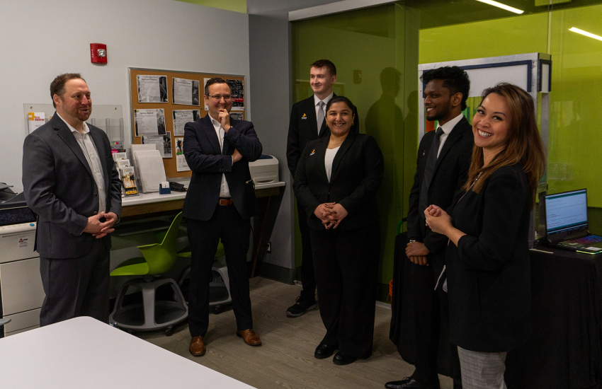 People smiling in front of displays