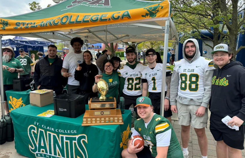 Football players at Saints booth