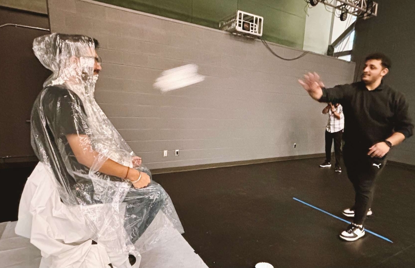 SRC President Rishi Vatish gets pied by SRC board member Ali Hadwan during the 'pie your prof' fundraiser on Dec. 6, 2024. (Rich Garton/St. Clair College)