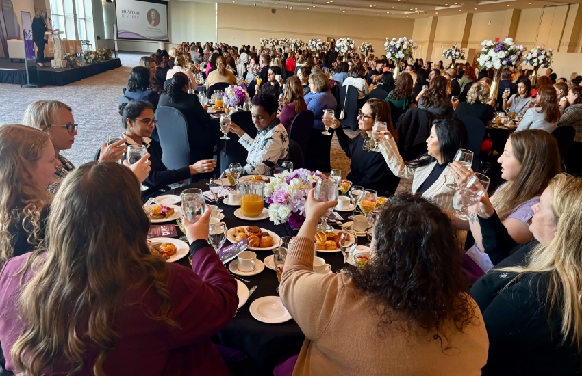 International Day of the Girl guests raise their glasses to toast women at the annual stakeholder breakfast at the St. Clair College Centre for the Arts on Oct. 9, 2025. 
