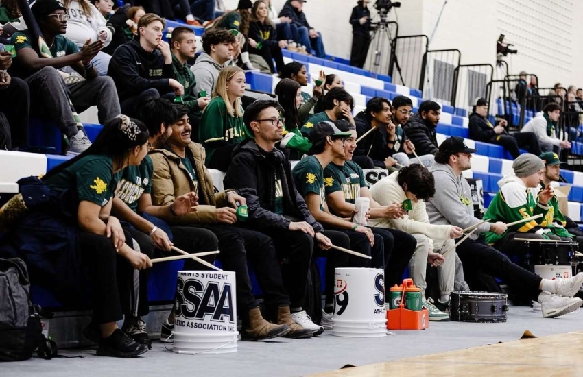 Saints fans make some noise during a 'Saints on the Road' trip to an opposing school's basketball game.