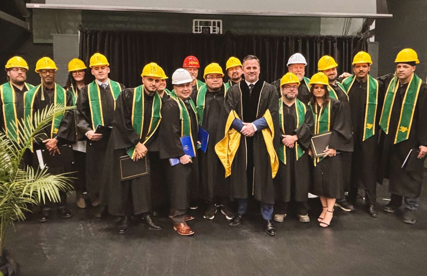 Graduates of the Battery Manufacturing Certificate program at St. Clair College standing with College President Michael Silvaggi