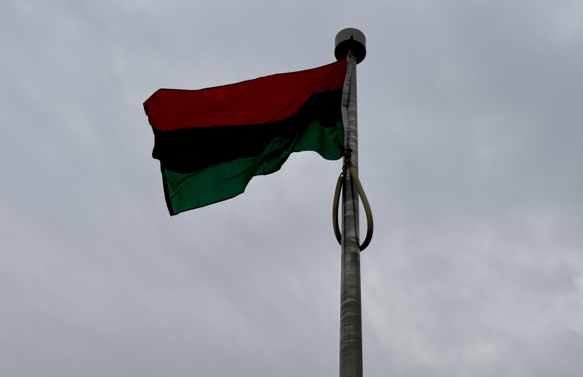 Black History Month flag on pole flowing in the wind