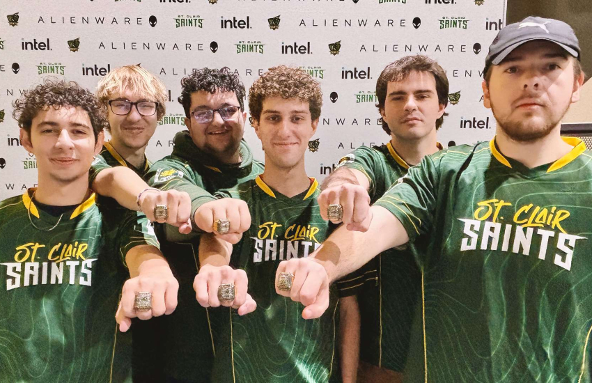Members of the Saints Esports team showing off their rings