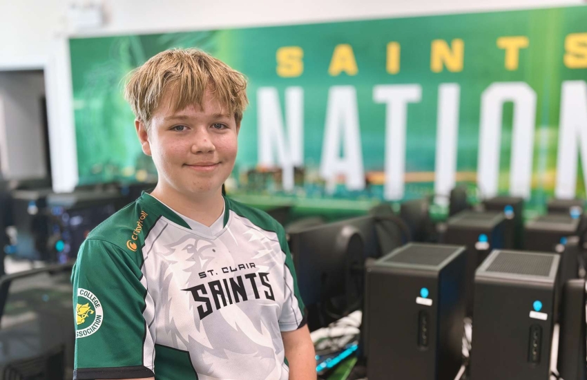 Jesse Amos poses for a photo inside the Alienware Gaming Lounge