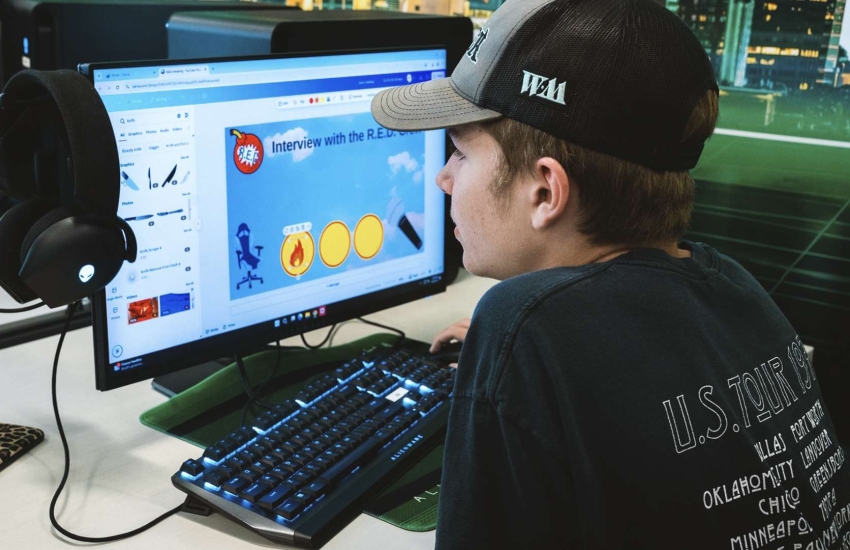 A camper on a computer at the 2025 Esports Summer Boot Camp