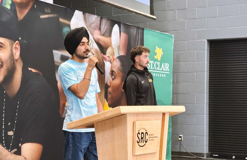 SRC President speaking at podium