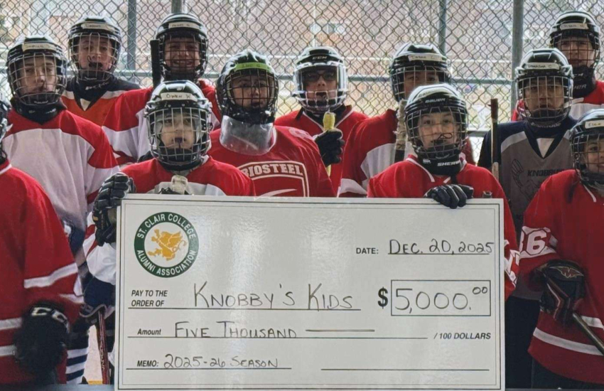 Knobby's Kids holding a cheque from St. Clair Alumni at Lanspeary Park on Dec. 20, 2025.