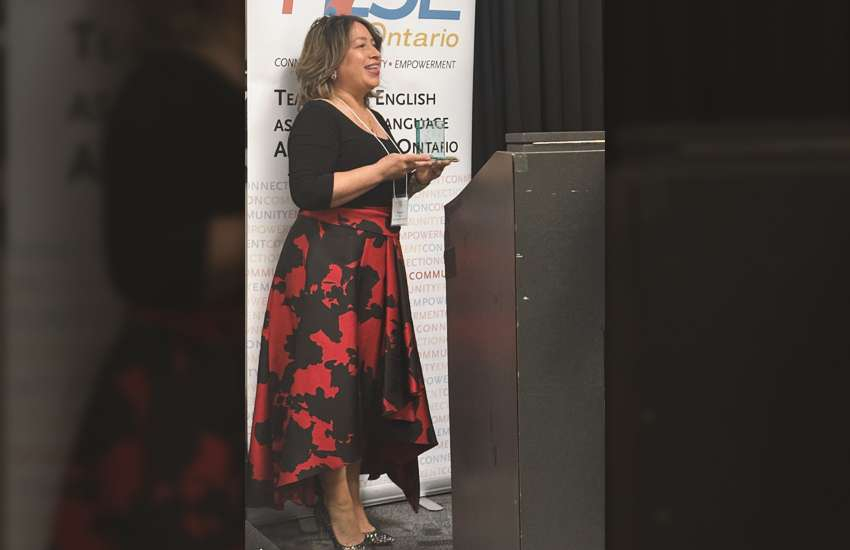 Margaret Holec holds her Sparks of Excellence Award