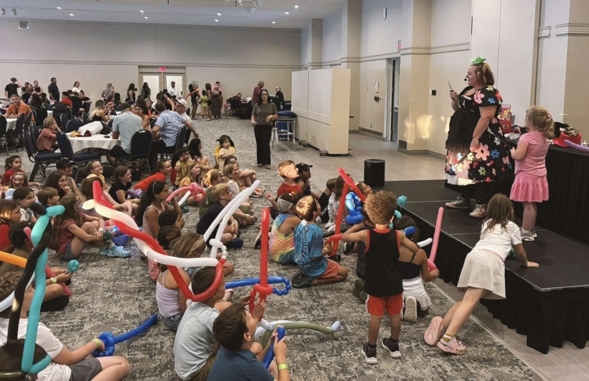 Kids enjoying a magic show during the St. Clair College Fireworks Night party
