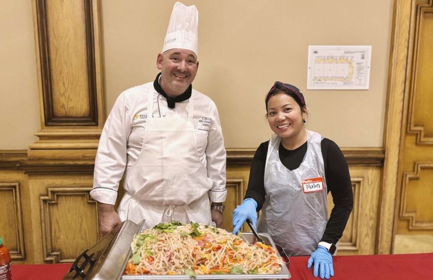 Chef Mike Jimmerfield and an assistant serve up an Asian shrimp stir-fry noodle dish