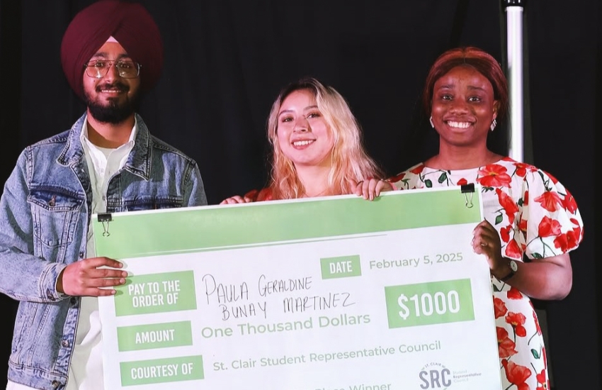 Second-year St. Clair College Journalism student Paula Bunay receives a $1,000 cheque