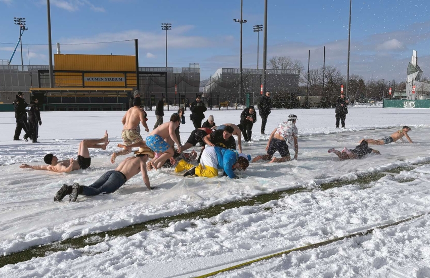St. Clair College students slip and slide across an icy field