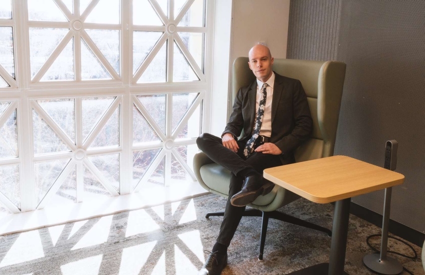 Sam McCutcheon poses inside Harvard Medical School